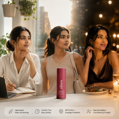 Three women seated at a table in a warm indoor setting, with a pink cylindrical sunscreen bottle centered in front of them. The bottle has the brand name 'zifora' printed vertically on it.